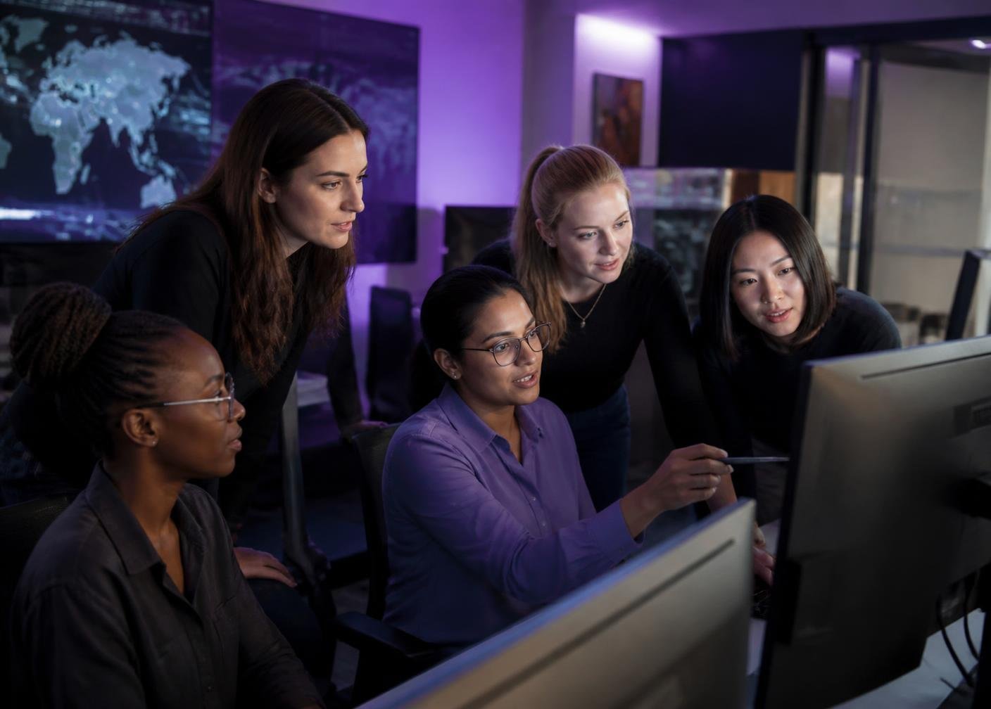 A group of women collaborating in a security operations workspace